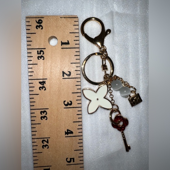 Gold-tone keychain bag charm floral design and lock and key accents - Picture 3 of 5